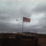 US Flag, hole shot in it during fire mission