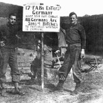 Battery A sign as 17th entered Hirschlhal, Germany, 1944 (L-R) Walt Larson, Lewis Roznosky
